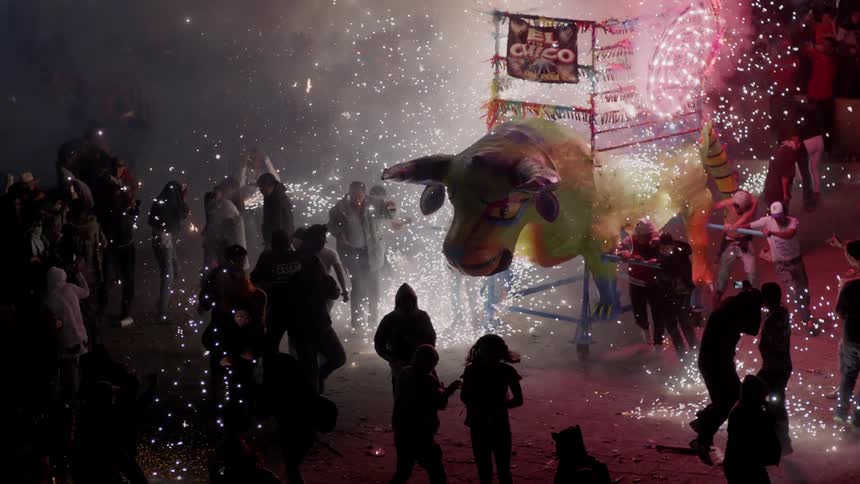 A festival with a bull shaped firework display