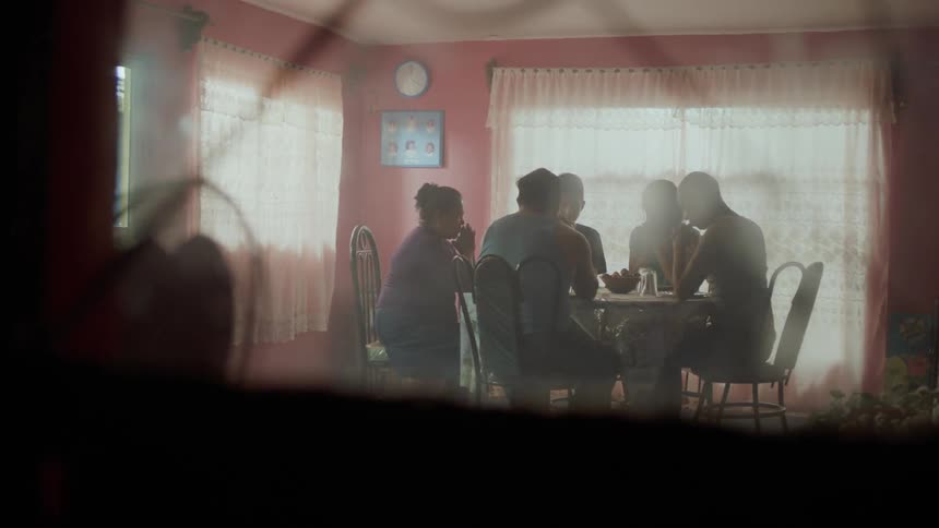 A family prays at the dining table