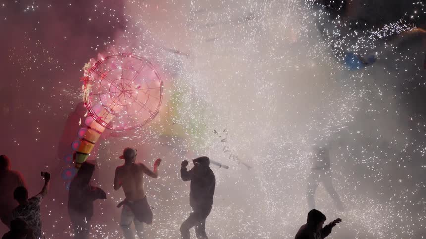 A large outdoor festival party with fireworks and sparklers