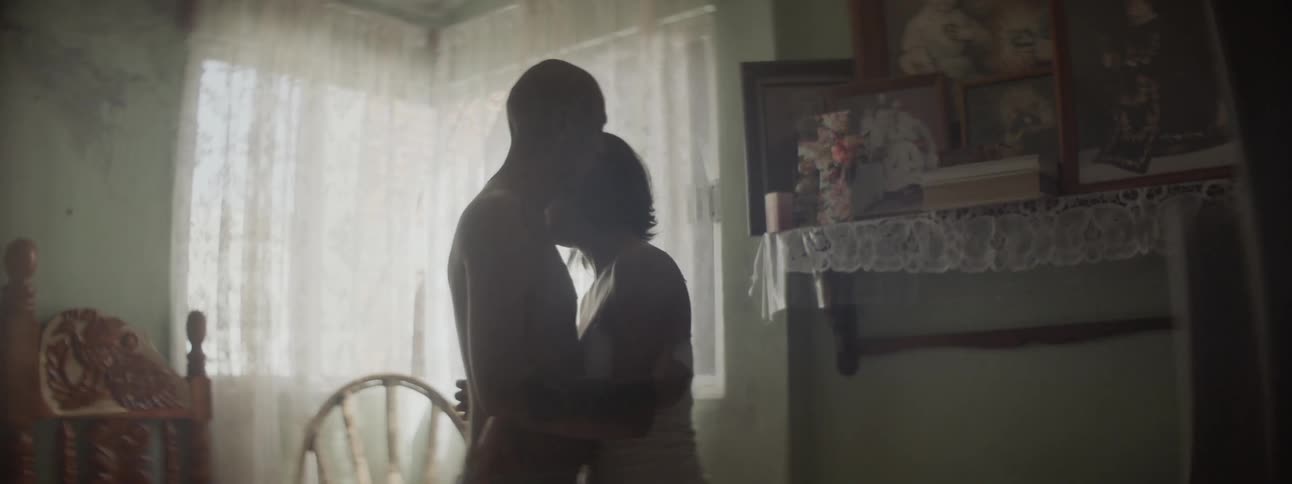 Couple talks and hugs in bedroom