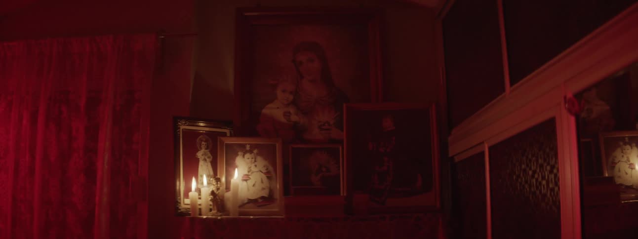 Pictures on display with candles