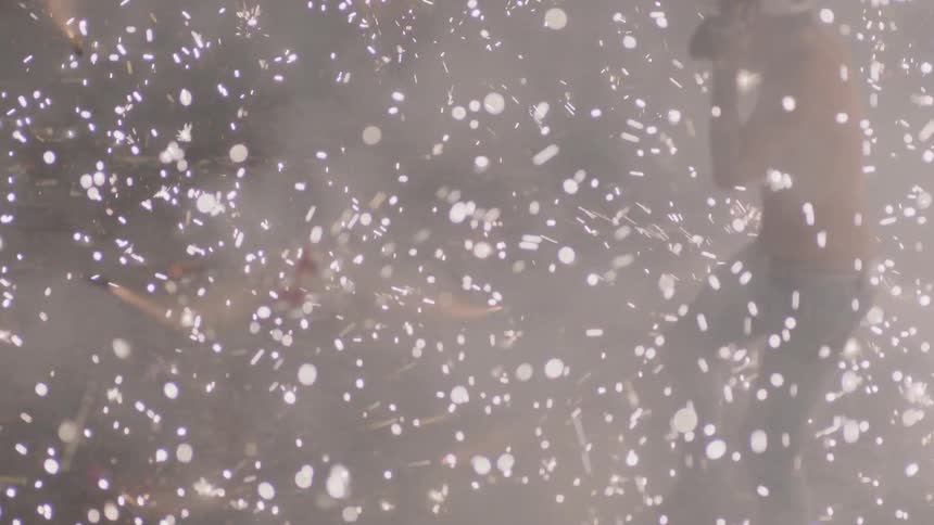 People jumping as confetti flies through the air