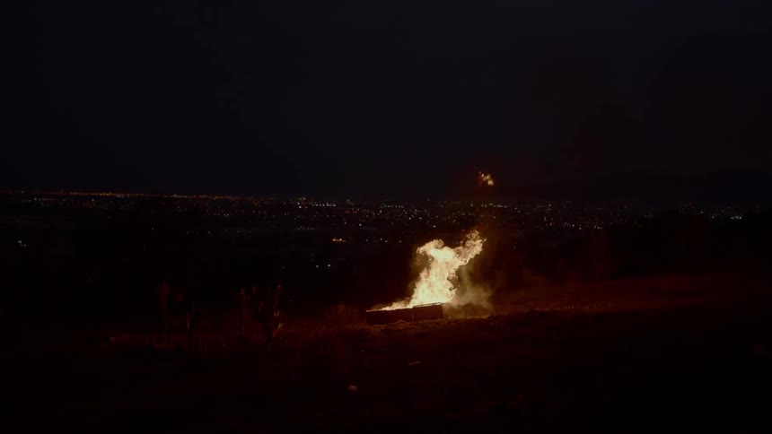 A fire burns on the land