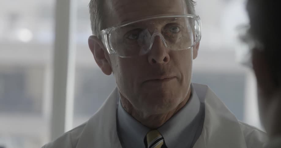 A man wearing goggles talks to another person in goggles