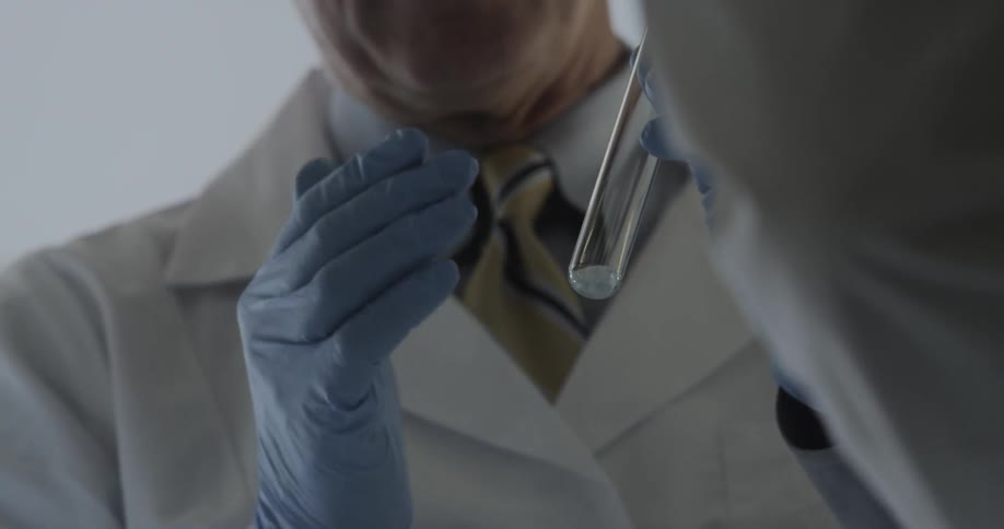A scientist holds a test tube and talks about the contents