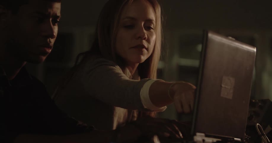 A man and a woman looking at a laptop