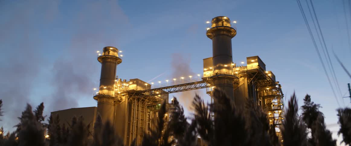 Lights illuminating a factory in the evening
