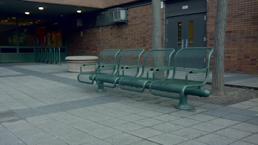 A row of metal benches in front of a building