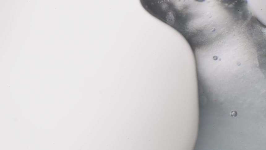 Gray liquid flows and evaporates on white background