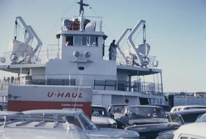 Cars are parked on the deck of a ferry