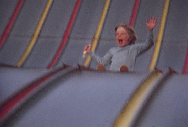 A child sliding down a large slide