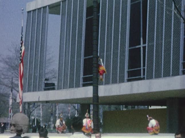 Man in ancient chinese garb climbing a pole