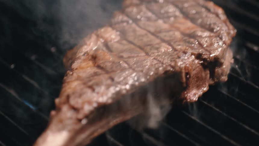 A lamb chop being grilled