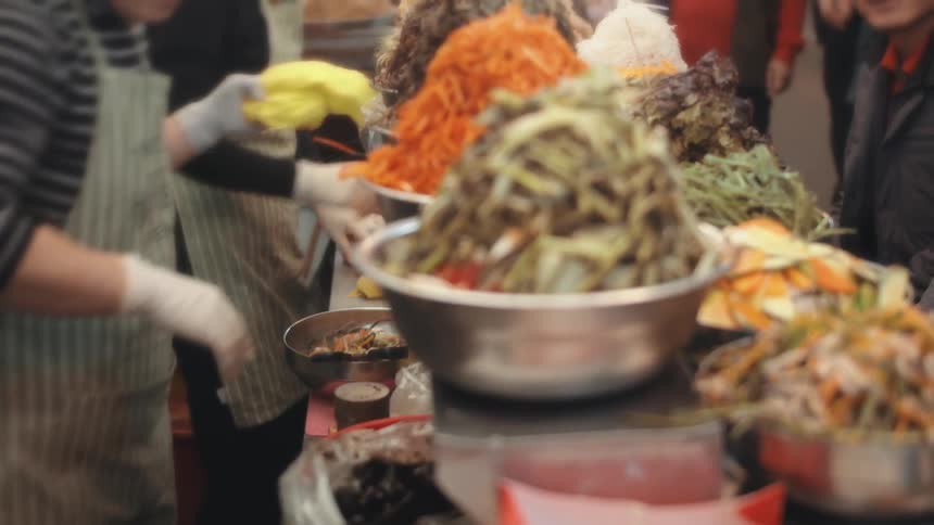 Silver bowls containing large piles of food on a counter at a restaurant