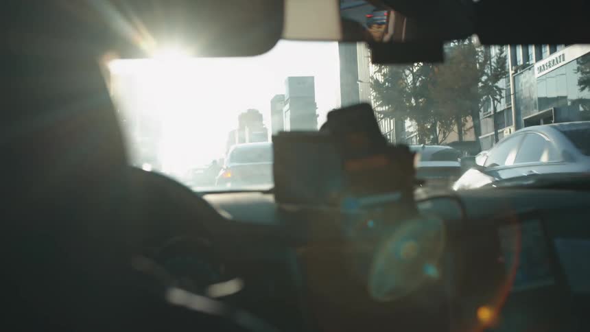 A person driving a vehicle through a metropolis