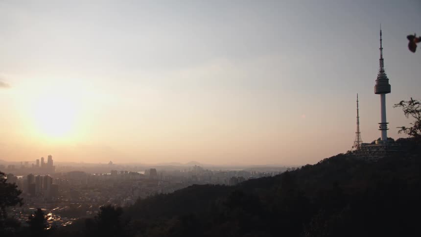 The sun rises over a neighborhood that sits at the bottom of a hill