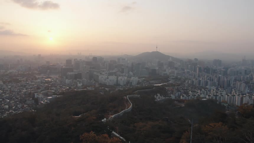 Buildings cover hillsides in a metropolitan area