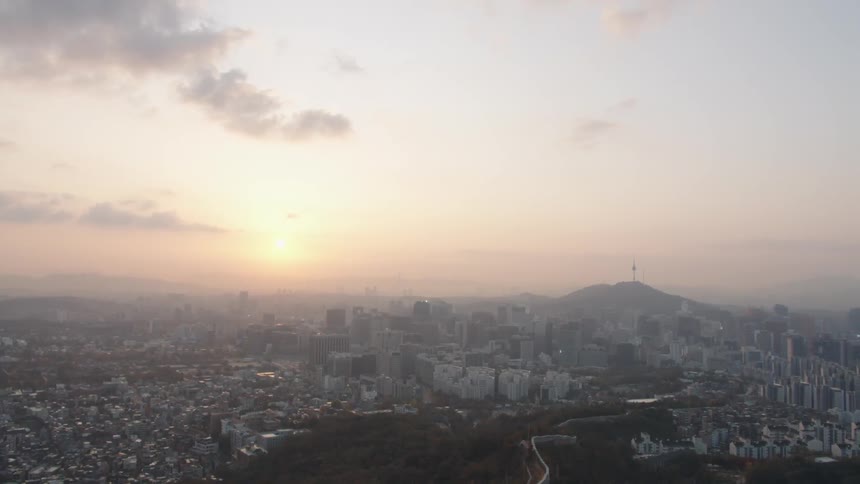 A city with buildings with the sky and clouds in the background