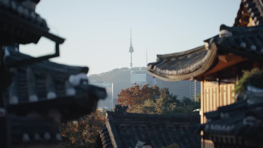 Two buildings against the sun