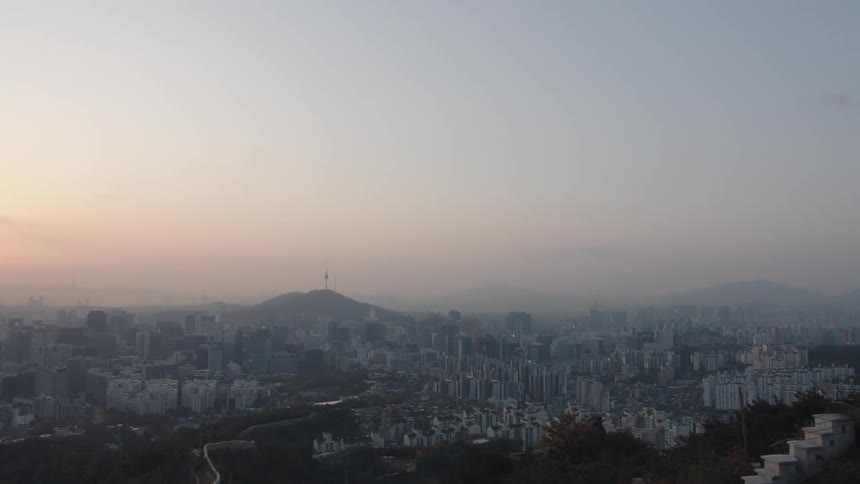The skyline of a sprawling city can be seen extending far into the distance