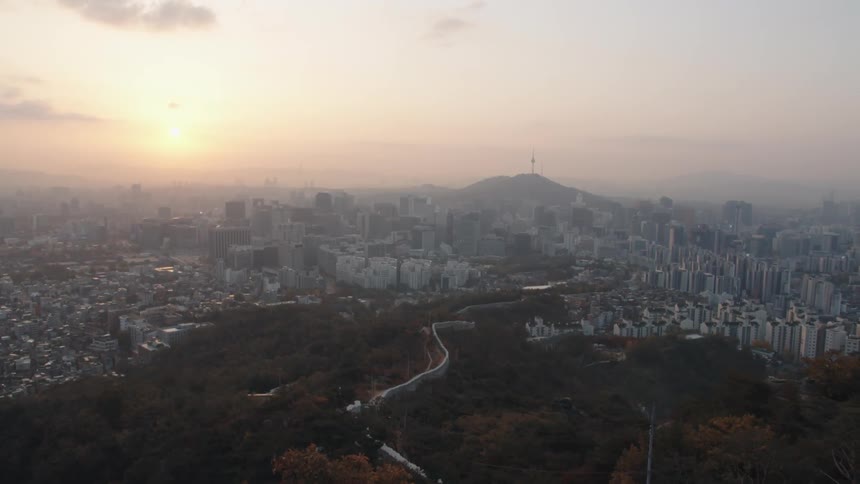 The city below is covered with fog