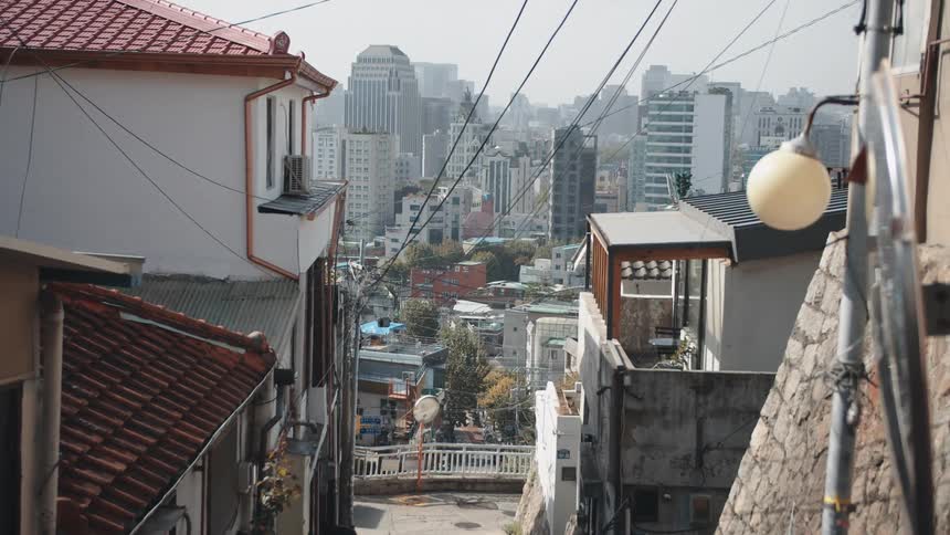 A neighborhood on a hill overlooking the downtown area in an asian country