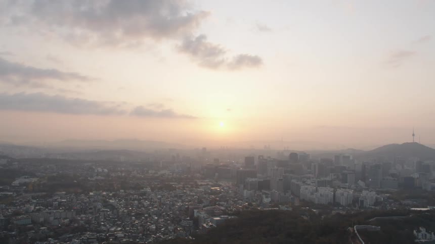 A sprawling city skyline with surrounding neighborhoods
