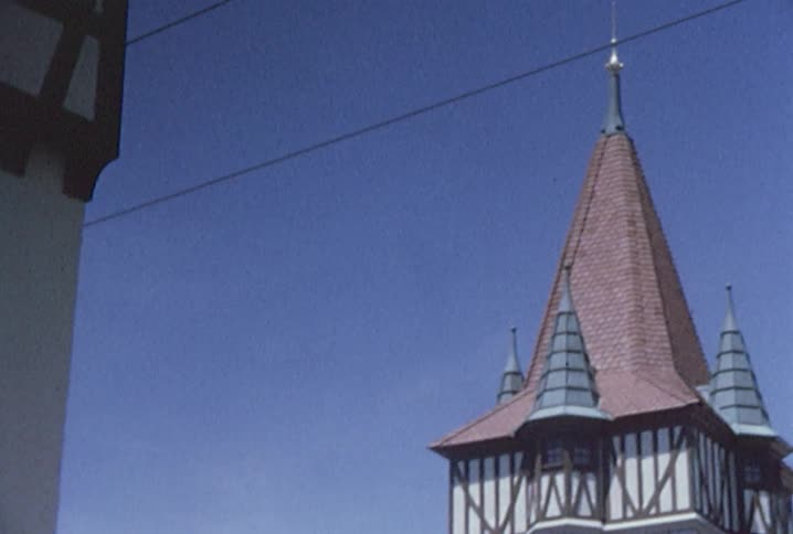 Top of a tall building is shown on a sunny day
