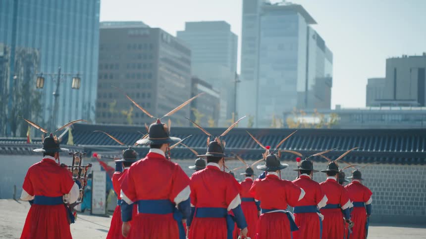 A group of people in uniform march playing instruments