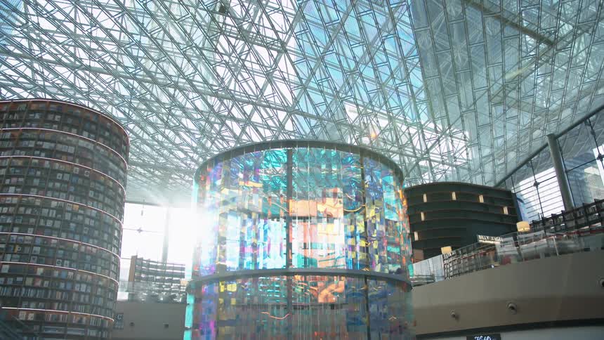 The building has many glass windows on the roof and wall