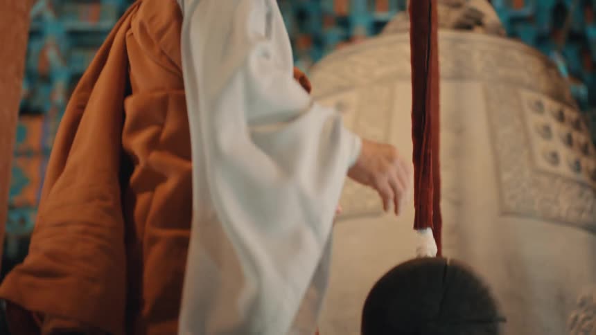 A monk rings the large bell