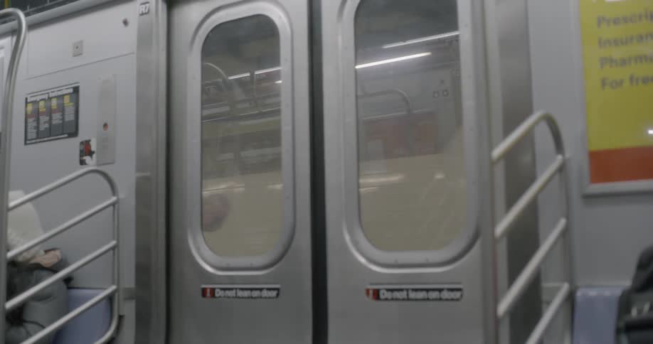 Subway car going through empty station