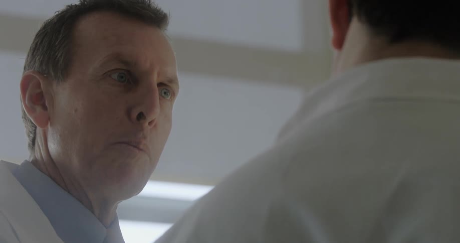 Two men in white coats talk