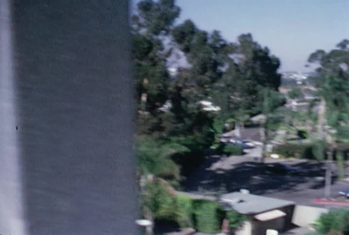 Old footage of a parking lot and buildings