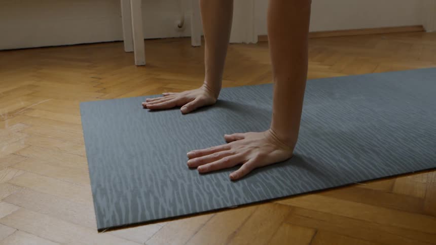 A young woman does yoga inside