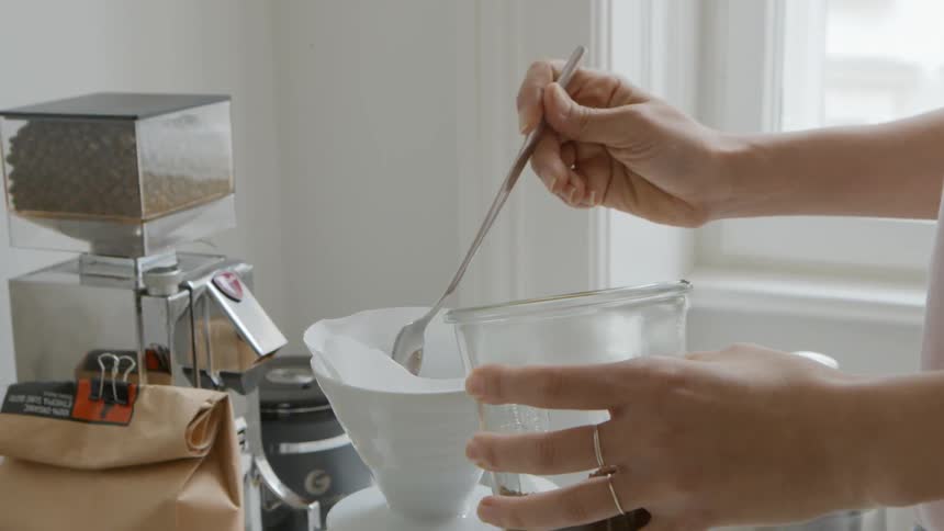 Scooping coffee into filter