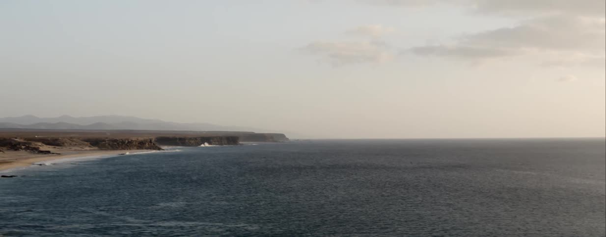 Aerial of waves lapping on shoreline in a cove