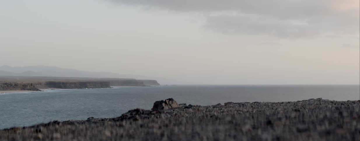 Rocks fill the shoreline next to the sea