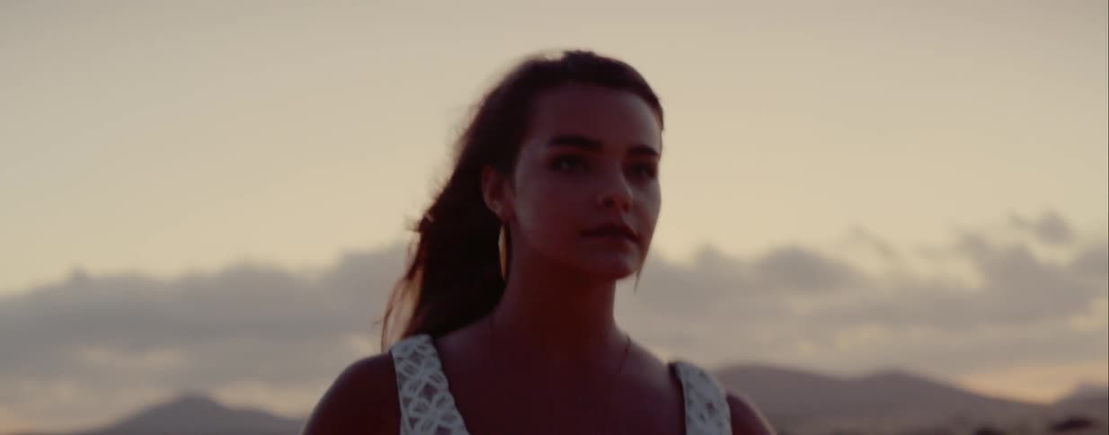 A woman is dancing in the desert