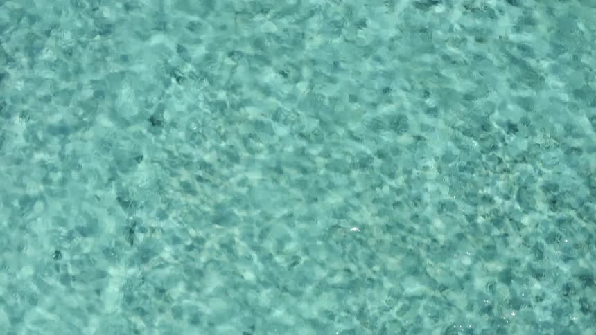 The water is clear and blue below
