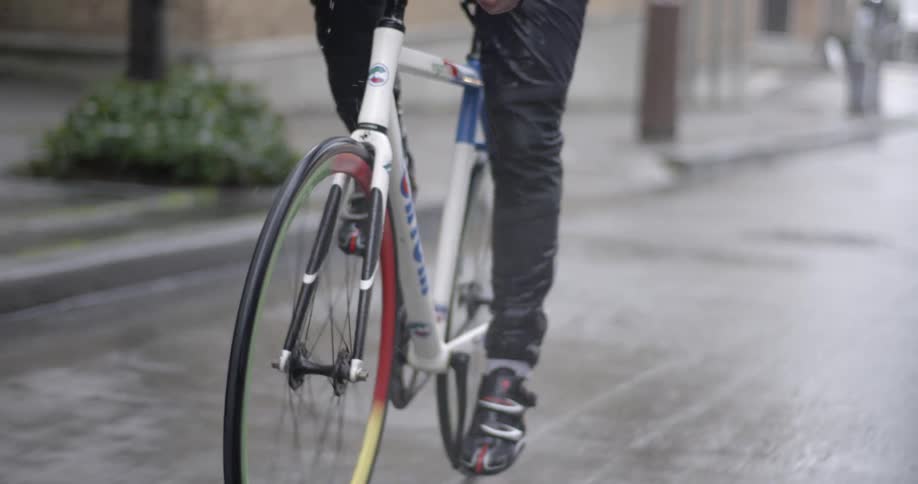 A person rides their bike down a street