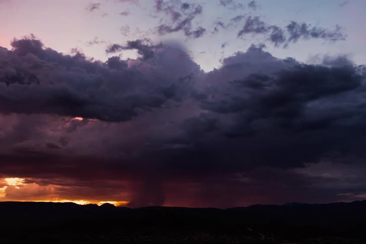 A storm moves over a vast landscape