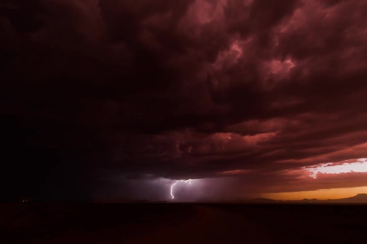 Timelapse of a thunderstorm over a desert from dusk to night time