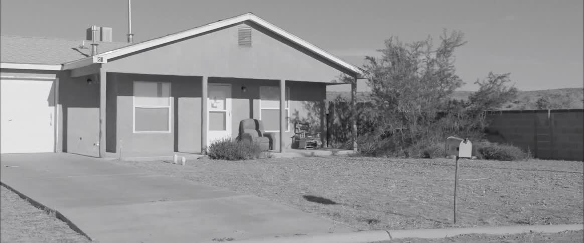 The yard in front of the home is empty