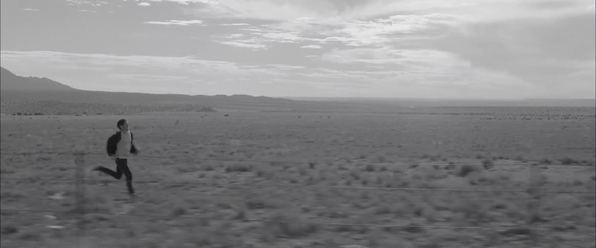 A person runs through a vast open plain