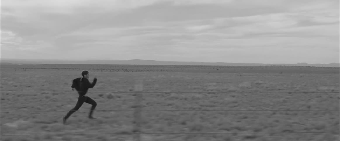 A man runs across a field