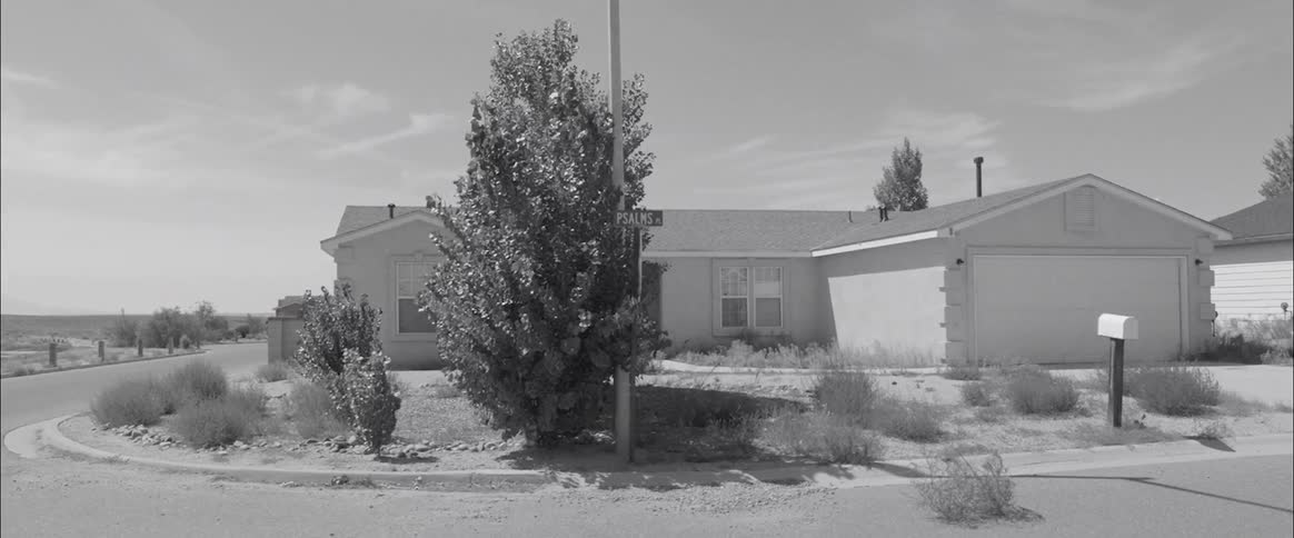 A house sits on the corner of a street
