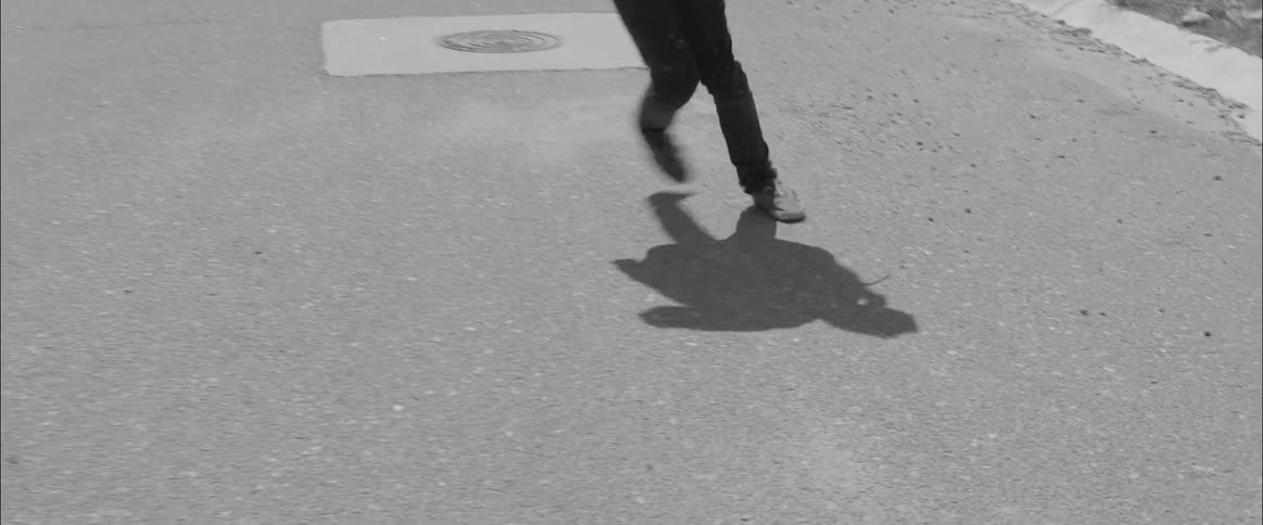 Person staggers along street twisting ankle