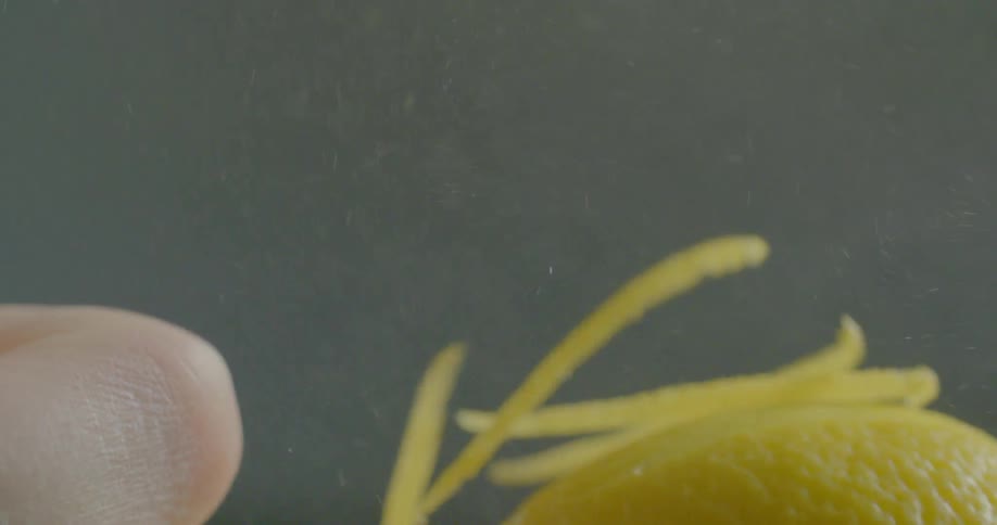 A kitchen tool pulls zest off of a lemon