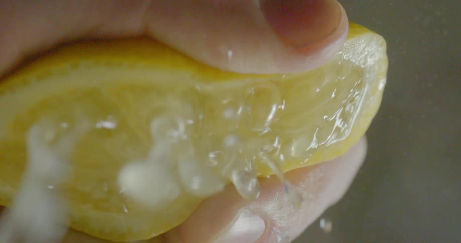 Lemon juice splashes out of lemon